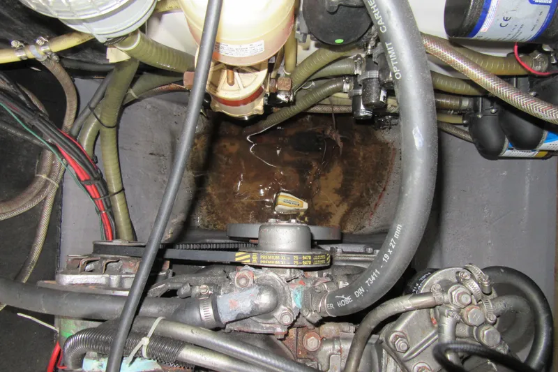 Pippin Yacht Photos Pics Engine compartment of a 2001 Catana 471 with visible hoses and wiring.