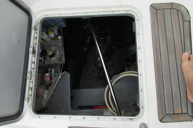 Pippin Yacht Photos Pics Open hatch on 2001 Catana 471 sailboat, revealing storage and engine compartment.