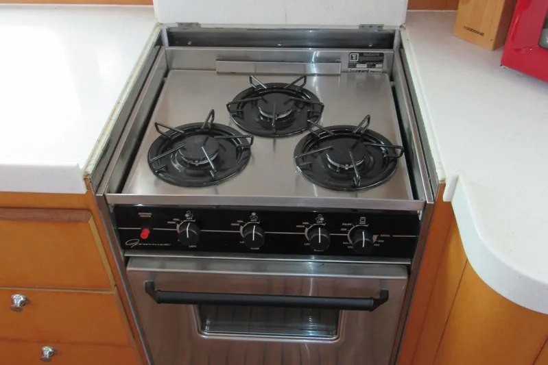Pippin Yacht Photos Pics Three-burner stove in a 2001 Catana 471 yacht kitchen, featuring stainless steel design.