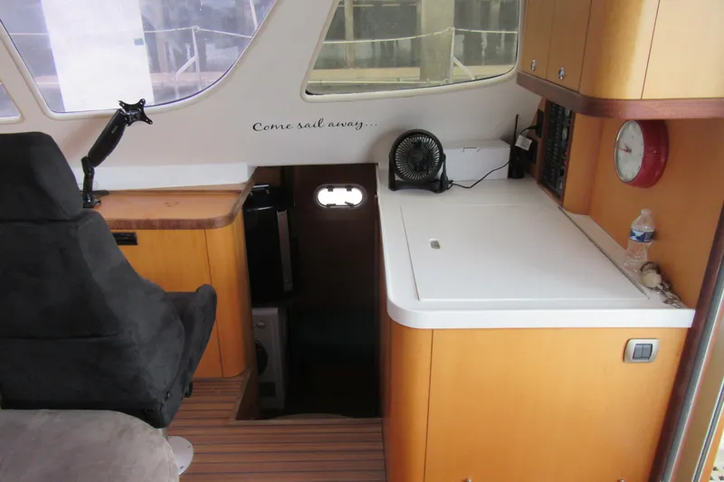 Pippin Yacht Photos Pics Interior of 2001 Catana 471 sailboat with navigation station and seating area.