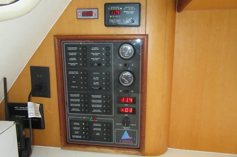 Pippin Yacht Photos Pics Electrical control panel on a 2001 Catana 471 yacht, featuring gauges and switches.