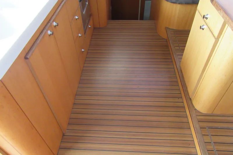 Pippin Yacht Photos Pics Interior of 2001 Catana 471 yacht with wooden flooring and cabinetry.