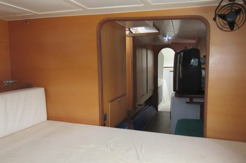 Pippin Yacht Photos Pics Interior of 2001 Catana 471 yacht, featuring wooden paneling and compact living space.