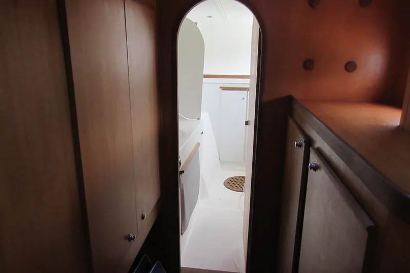 Pippin Yacht Photos Pics Interior view of 2001 Catana 471 yacht, featuring wooden cabinetry and a compact bathroom.