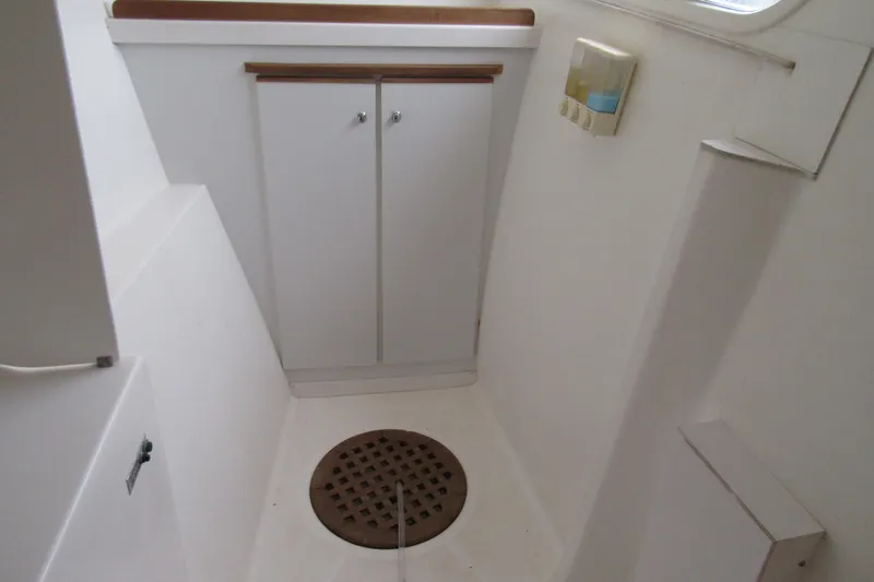 Pippin Yacht Photos Pics Interior of 2001 Catana 471 yacht, featuring a compact white bathroom with storage cabinet.