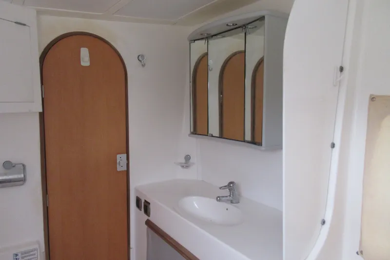 Pippin Yacht Photos Pics Bathroom interior of 2001 Catana 471 yacht with sink and mirrored cabinet.