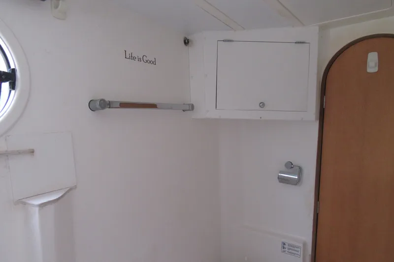 Pippin Yacht Photos Pics Interior of 2001 Catana 471 yacht bathroom with "Life is Good" text.