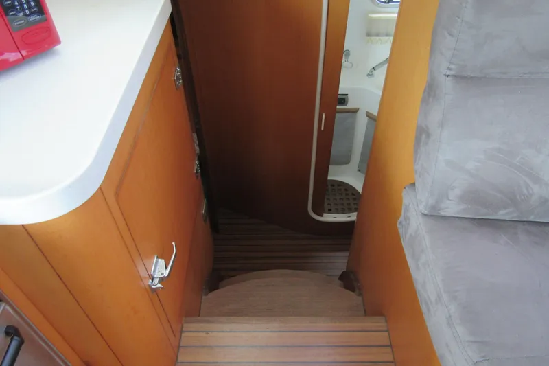 Pippin Yacht Photos Pics Interior of 2001 Catana 471 yacht showing stairs and compact bathroom.