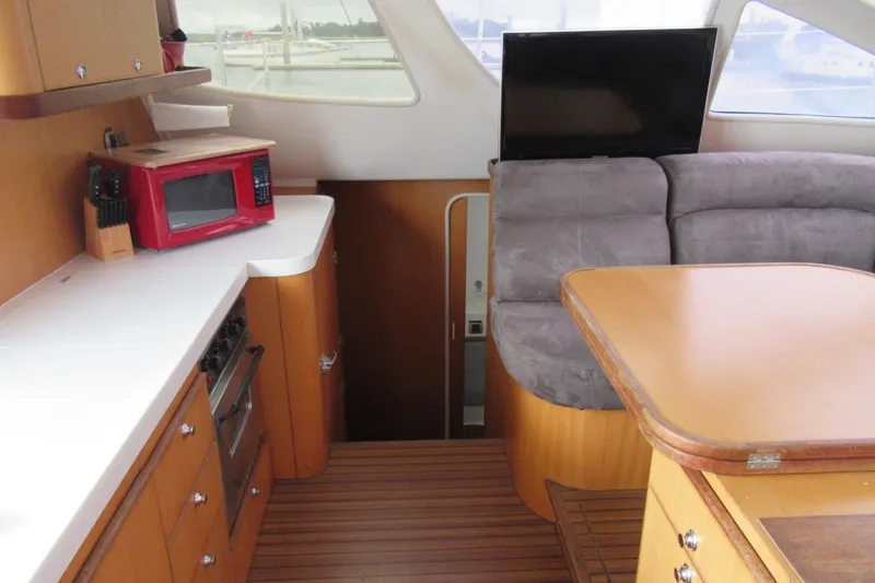 Pippin Yacht Photos Pics Interior of 2001 Catana 471 yacht with kitchen and seating area.