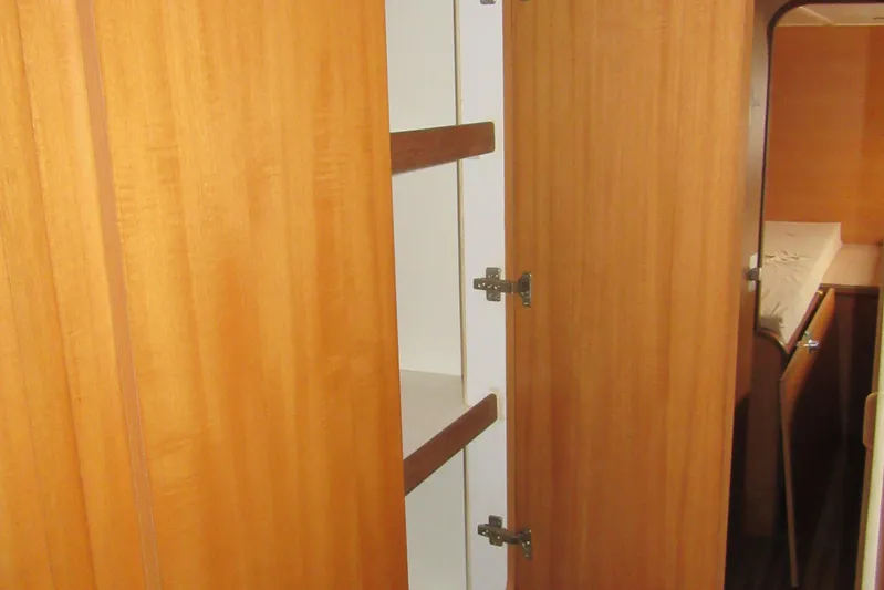 Pippin Yacht Photos Pics Interior of 2001 Catana 471 yacht showing wooden cabinetry and storage space.