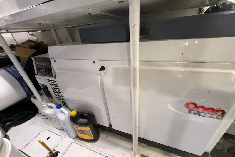 Enclosed Bridge W/tower Yacht Photos Pics Engine room of 2004 Viking 65 Enclosed Bridge with Onan generator and maintenance supplies.