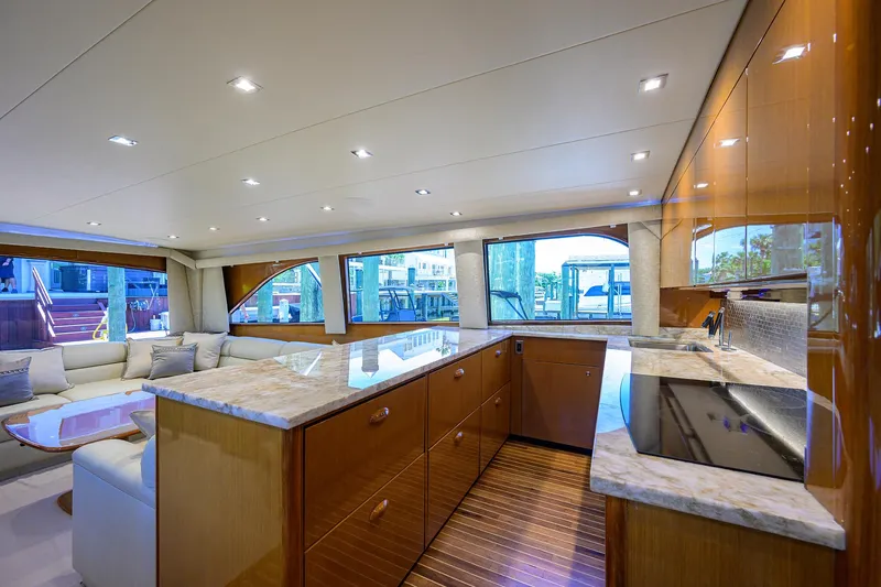 Enclosed Bridge W/tower Yacht Photos Pics Luxurious interior of 2004 Viking 65 Enclosed Bridge yacht with modern kitchen and seating area.