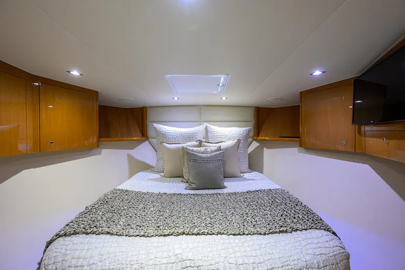 Enclosed Bridge W/tower Yacht Photos Pics Luxurious bedroom interior of 2004 Viking 65 Enclosed Bridge yacht with cozy bedding.