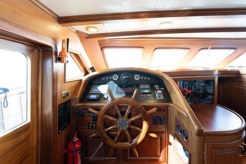 Take It Easier Yacht Photos Pics Luxurious 2007 Custom Gulet Motorsailer helm with wooden steering wheel and navigation instruments.