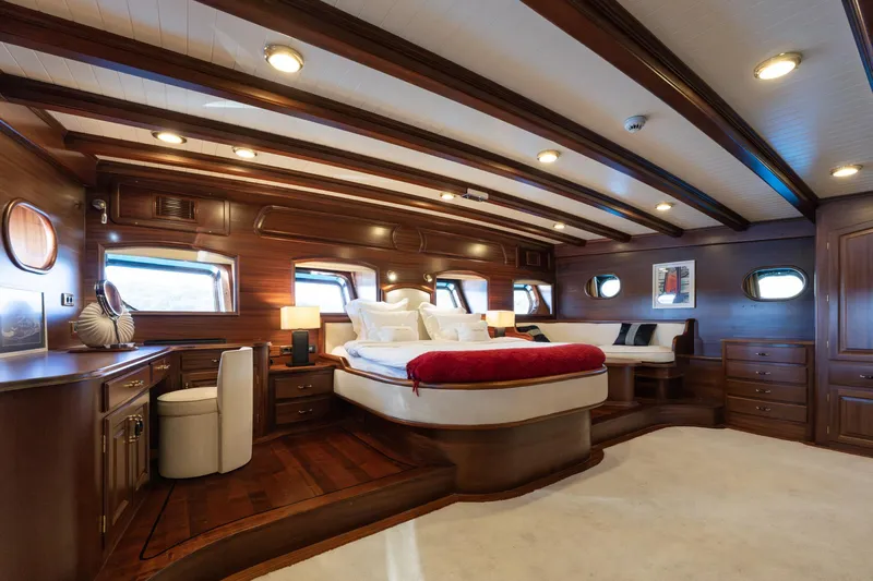 Take It Easier Yacht Photos Pics Luxurious 2007 Custom Gulet Motorsailer cabin with elegant wood interior and cozy bed.