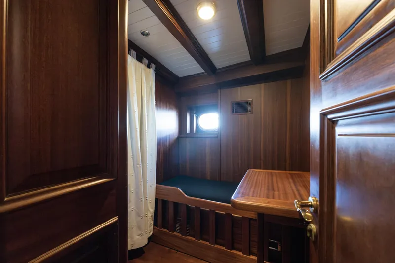 Take It Easier Yacht Photos Pics Cozy wooden cabin interior of 2007 Custom Gulet Motorsailer with bed and porthole window.