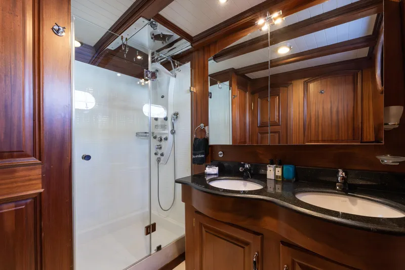 Take It Easier Yacht Photos Pics Luxurious wooden bathroom on 2007 Custom Gulet Motorsailer with dual sinks and glass shower.