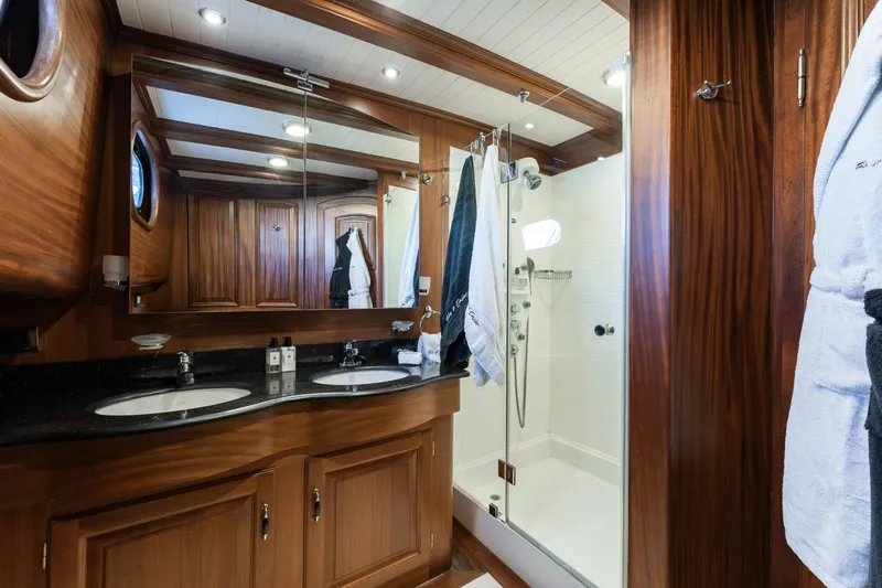 Take It Easier Yacht Photos Pics Luxurious bathroom in 2007 Custom Gulet Motorsailer with wood accents and dual sinks.