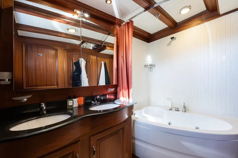 Take It Easier Yacht Photos Pics Luxurious bathroom in 2007 Custom Gulet Motorsailer with wood accents and modern fixtures.