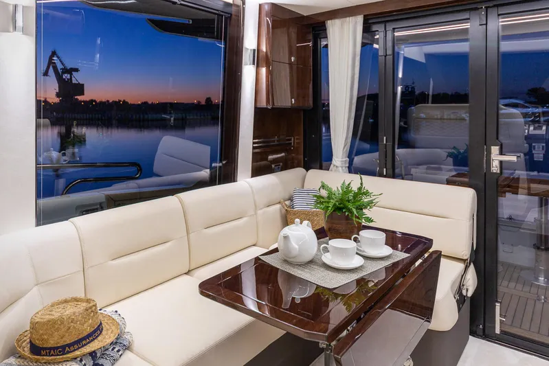  Yacht Photos Pics Luxurious interior of 2024 Galeon 400 Fly yacht with elegant seating and sunset view.