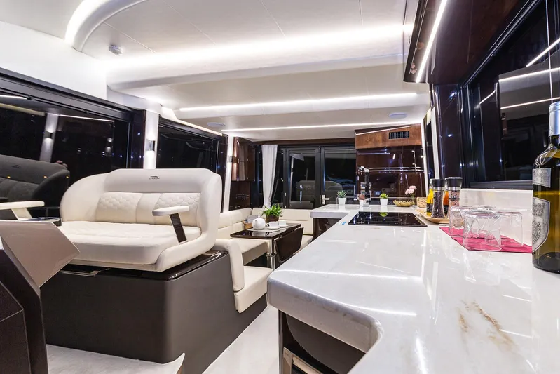  Yacht Photos Pics Luxurious interior of 2024 Galeon 400 Fly yacht with modern seating and kitchen area.