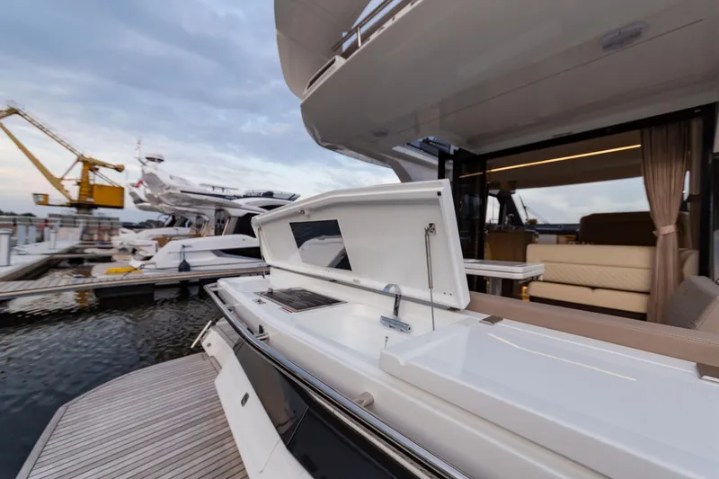  Yacht Photos Pics 2024 Galeon 400 Fly yacht with open deck and luxurious interior at a marina.