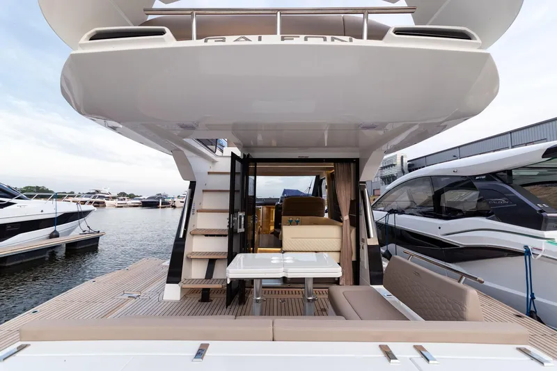  Yacht Photos Pics 2024 Galeon 400 Fly yacht with elegant deck and seating area at marina.