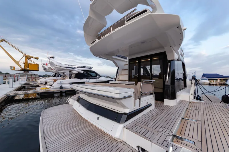  Yacht Photos Pics 2024 Galeon 400 Fly yacht docked, showcasing sleek design and spacious deck.