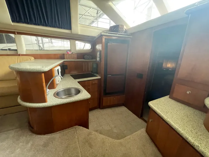 Sudden Comfort Yacht Photos Pics Interior of 2001 Carver 444 Cockpit Motor Yacht with modern kitchen amenities.