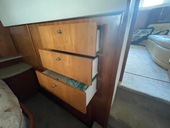 Sudden Comfort Yacht Photos Pics Interior view of 2001 Carver 444 Cockpit Motor Yacht with open wooden drawers.