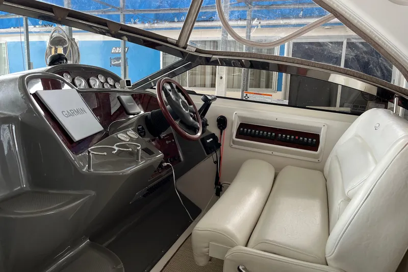 River Dancer Yacht Photos Pics 2007 Regal 3760 IB Commodore boat cockpit with Garmin navigation system and white seating.