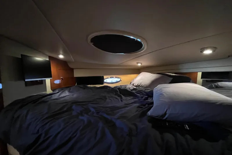 River Dancer Yacht Photos Pics Cozy cabin interior of 2007 Regal 3760 IB Commodore yacht with bed and ambient lighting.