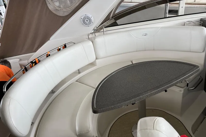 River Dancer Yacht Photos Pics 2007 Regal 3760 IB Commodore boat interior with white seating and a curved table.