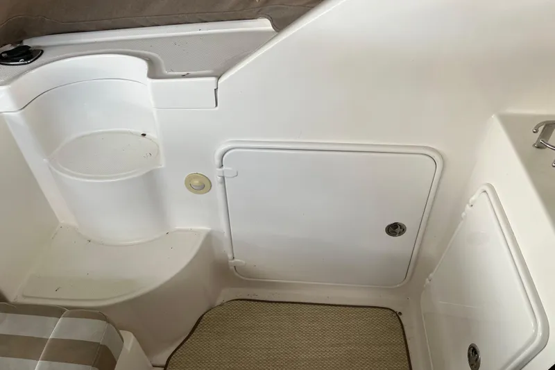 River Dancer Yacht Photos Pics 2007 Regal 3760 IB Commodore interior with white seating and storage compartment.