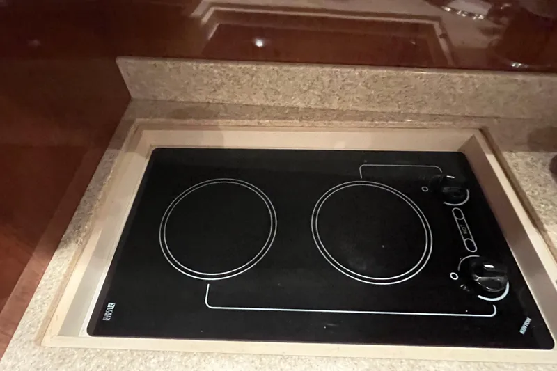 River Dancer Yacht Photos Pics Built-in stovetop on 2007 Regal 3760 IB COMMODORE yacht, featuring two burners.