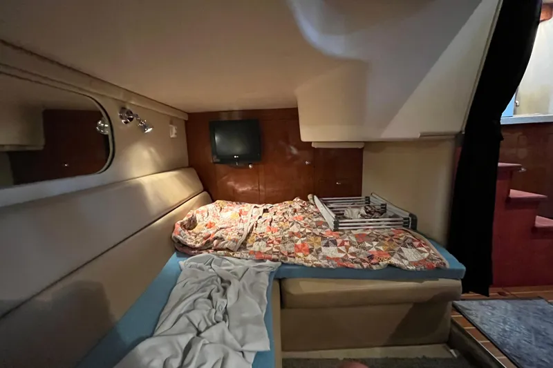 River Dancer Yacht Photos Pics 2007 Regal 3760 IB Commodore cabin with bed, TV, and cozy decor.