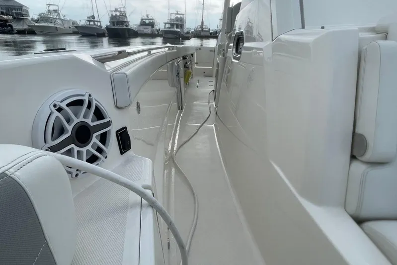 Equanimity Yacht Photos Pics 2021 Pursuit S 328 Sport boat interior with speaker, docked at marina.