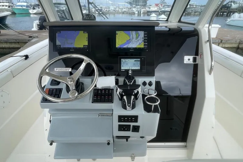 Equanimity Yacht Photos Pics 2021 Pursuit S 328 Sport boat helm with dual navigation screens and steering wheel.