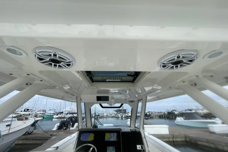Equanimity Yacht Photos Pics 2021 Pursuit S 328 Sport boat interior with Garmin electronics and marina view.