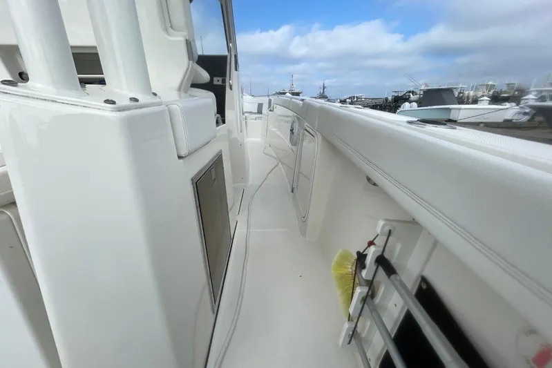 Equanimity Yacht Photos Pics 2021 Pursuit S 328 Sport boat deck with white seating and storage compartments.