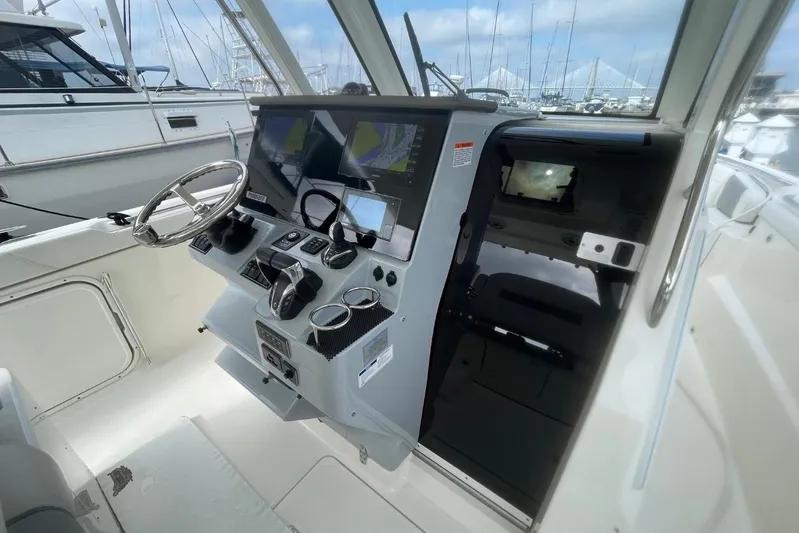 Equanimity Yacht Photos Pics 2021 Pursuit S 328 Sport boat helm with advanced navigation displays and controls.