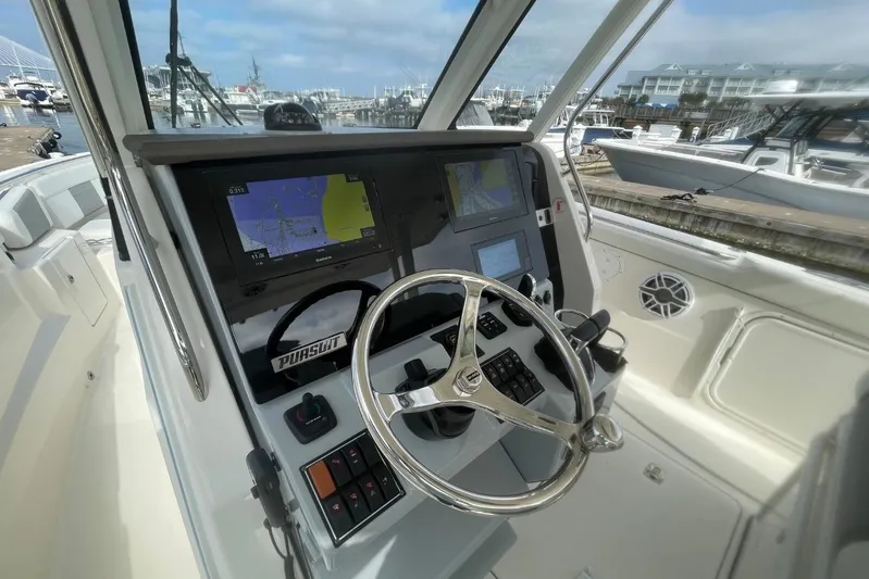 Equanimity Yacht Photos Pics Helm of 2021 Pursuit S 328 Sport boat with navigation screens and steering wheel.