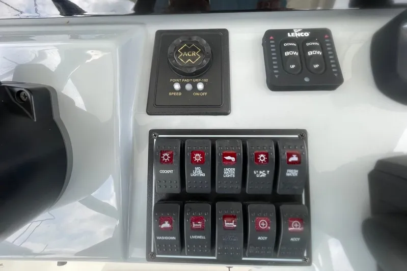 Equanimity Yacht Photos Pics Control panel of 2021 Pursuit S 328 Sport boat with various switches and buttons.