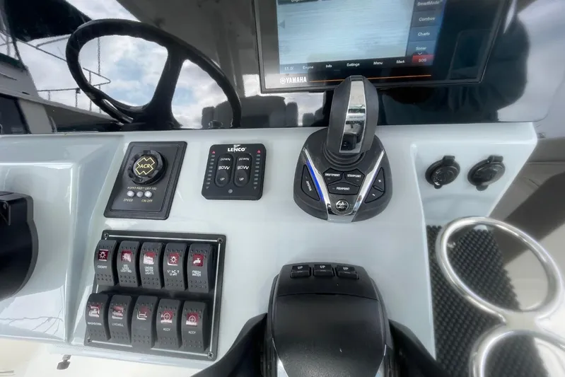 Equanimity Yacht Photos Pics 2021 Pursuit S 328 Sport boat dashboard with controls and display screen.