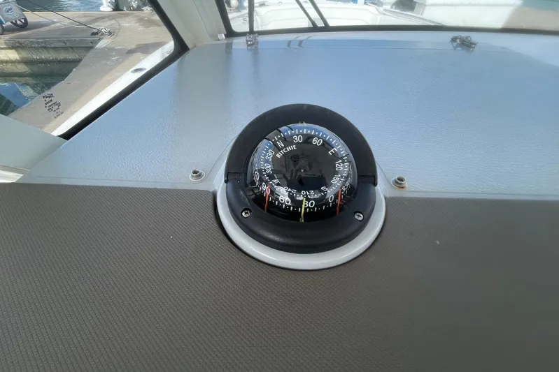 Equanimity Yacht Photos Pics Compass on 2021 Pursuit S 328 Sport boat dashboard, dockside view.