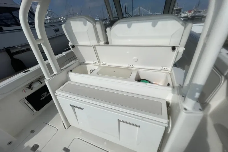 Equanimity Yacht Photos Pics 2021 Pursuit S 328 Sport boat interior with open storage compartments.