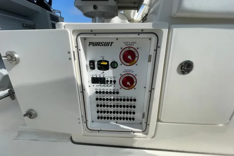 Equanimity Yacht Photos Pics Control panel of a 2021 Pursuit S 328 Sport boat, featuring engine and generator switches.