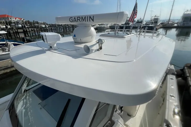 Equanimity Yacht Photos Pics 2021 Pursuit S 328 Sport boat with Garmin radar, docked in a marina.