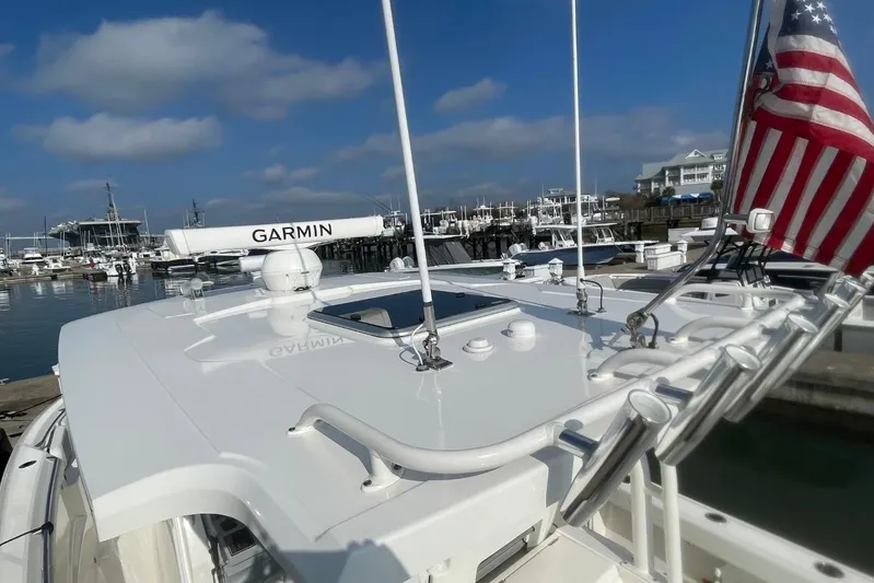 Equanimity Yacht Photos Pics 2021 Pursuit S 328 Sport boat docked, featuring Garmin equipment and American flag.