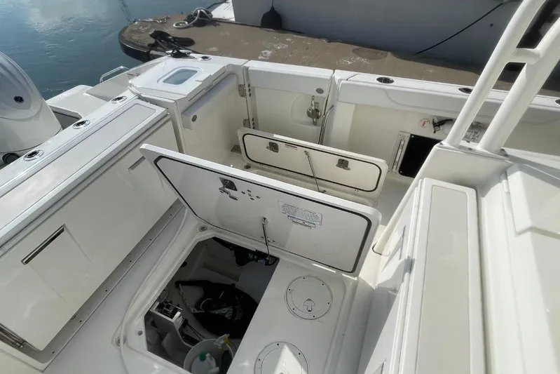 Equanimity Yacht Photos Pics 2021 Pursuit S 328 Sport boat interior with open storage compartments at dock.